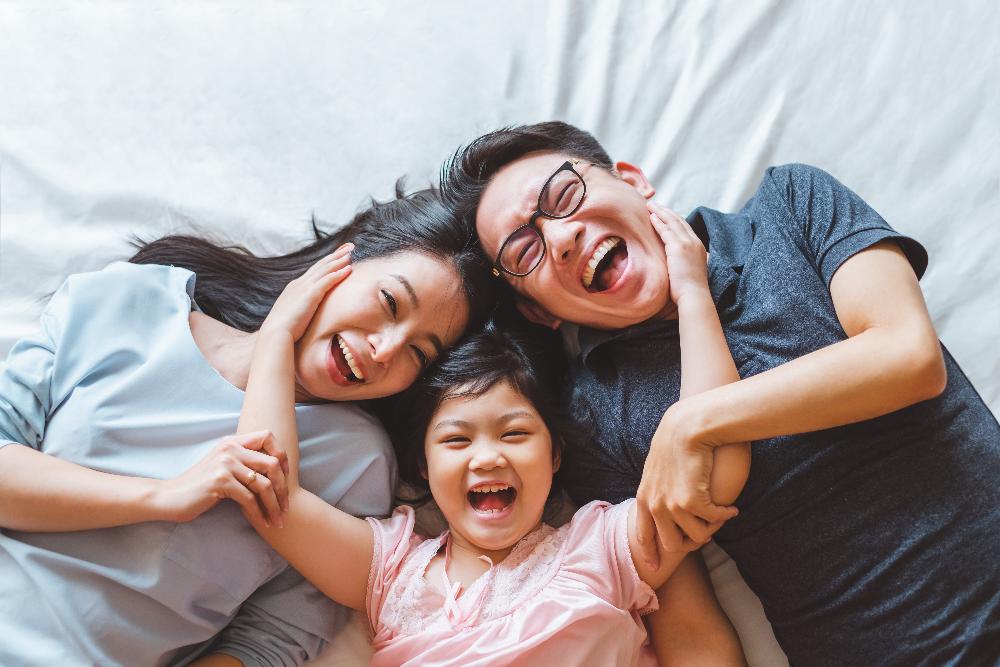 A smiling family in bed